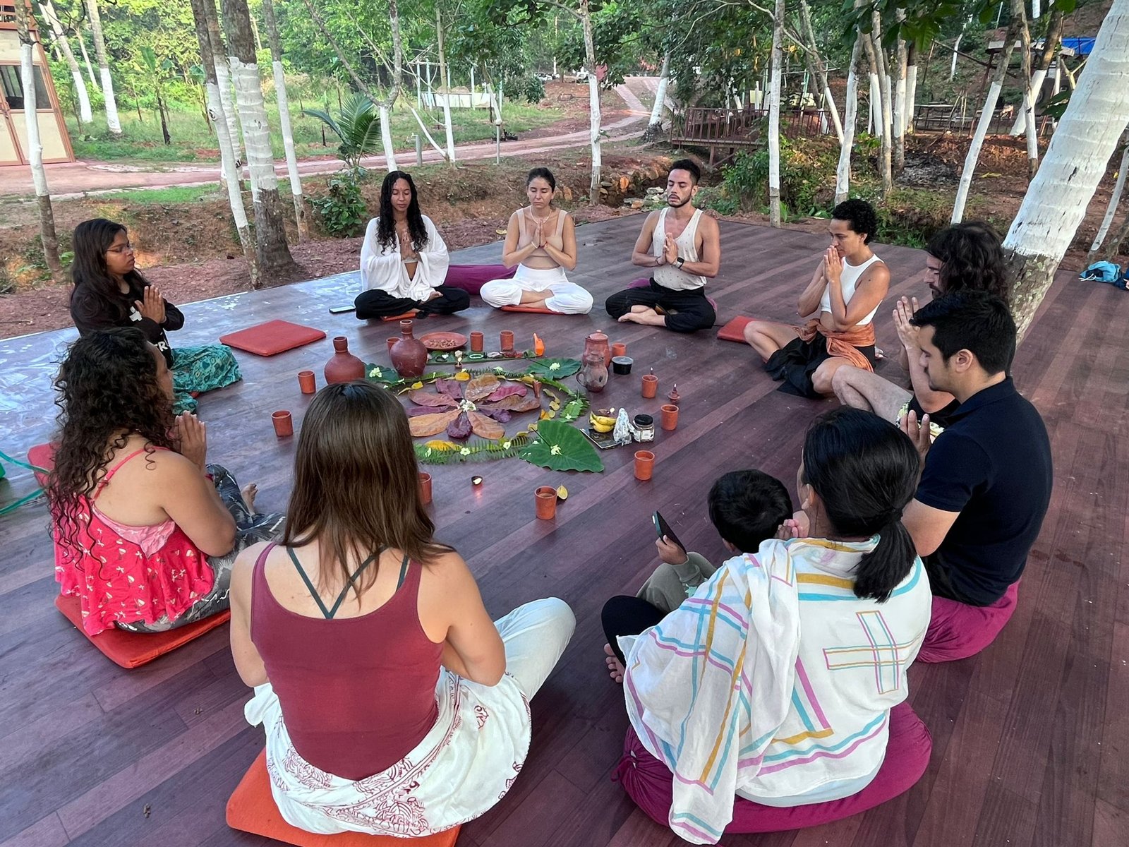 A group sitting in a circle in a mindfulness gathering outdoors